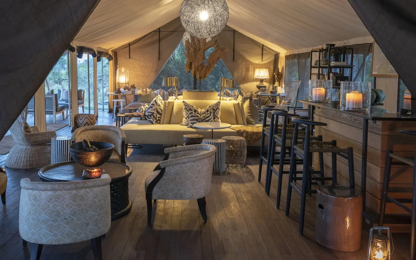 Luxury tent interior with seating and bar area, Gomoti Plains, The Okavango Delta, Botswana