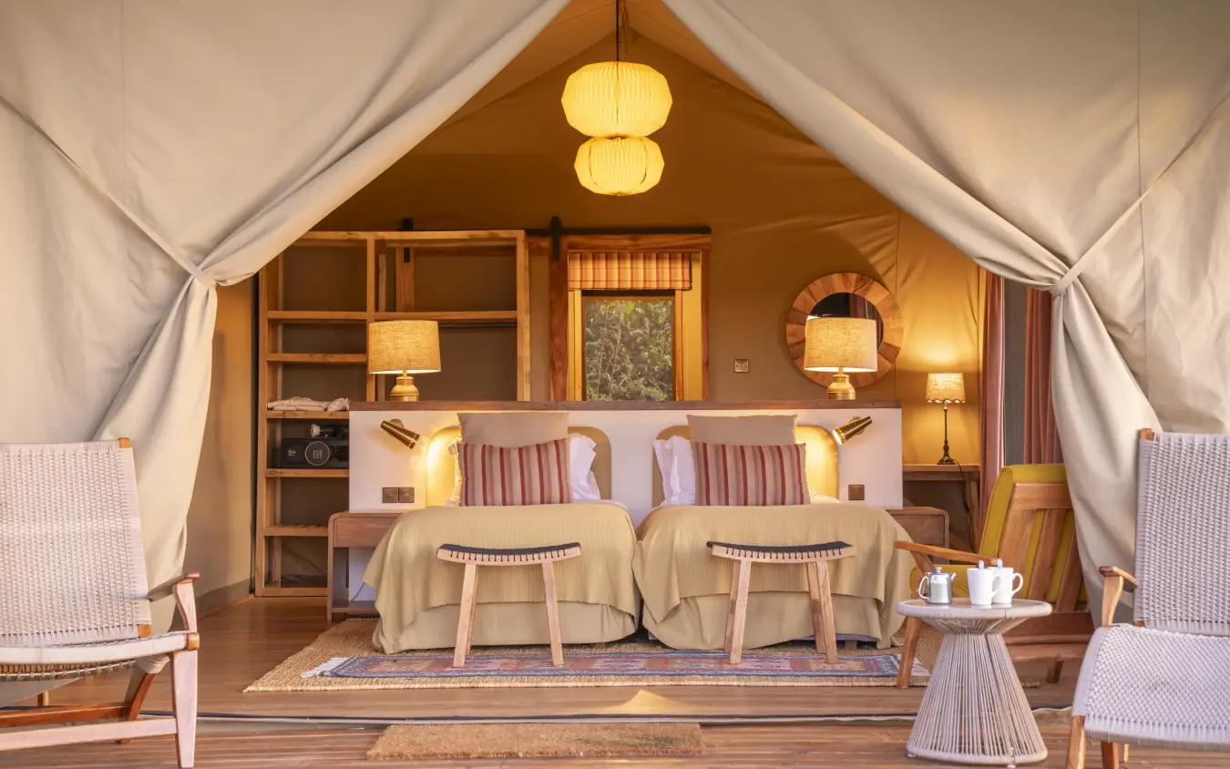 Luxury safari tent interior with twin beds and canvas walls, Governors’ Camp, Maasai Mara, Kenya