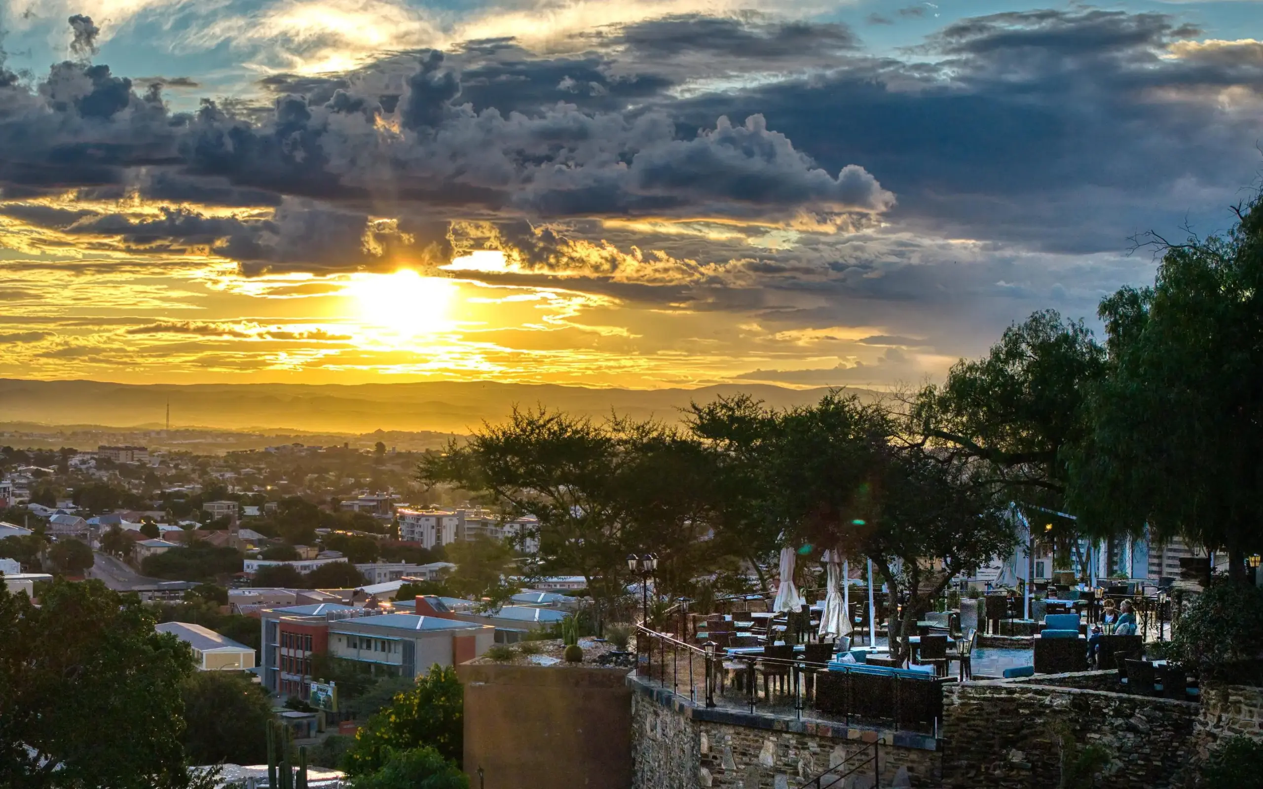 Sunset view over city and surrounding landscape from hilltop, Namibia