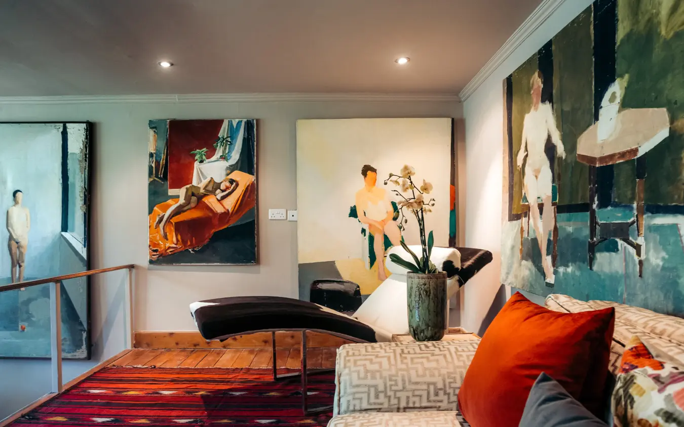 Contemporary bedroom with artwork and curved seating, Hemingways Eden Residence, Nairobi, Kenya