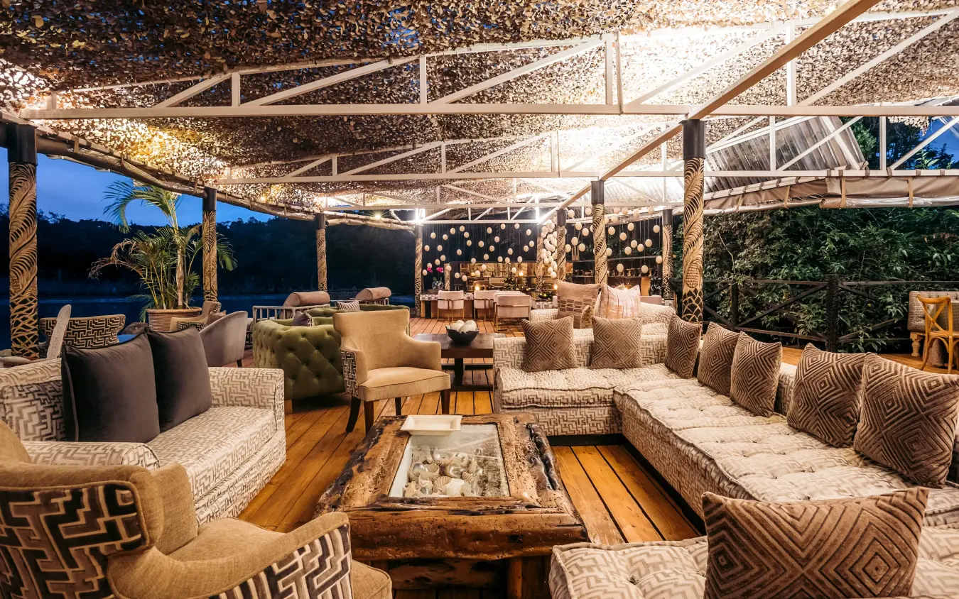 Evening lounge with firepit seating and overhead lighting, Hemingways Eden Residence, Nairobi, Kenya