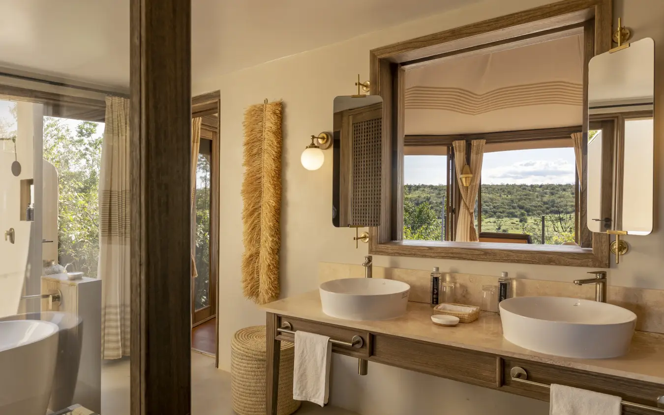 Luxury bathroom with double vessel sinks overlooking savanna landscape, Hemingways Ol Seki Mara, Maasai Mara, Kenya