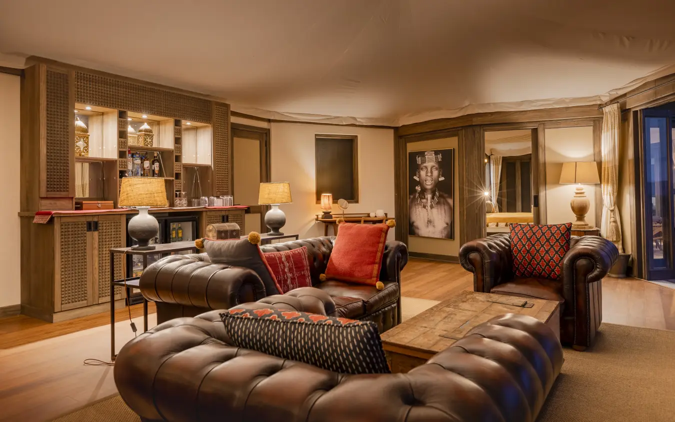 Luxury lounge suite with leather furnishings and warm ambient lighting, Hemingways Ol Seki Mara, Maasai Mara, Kenya
