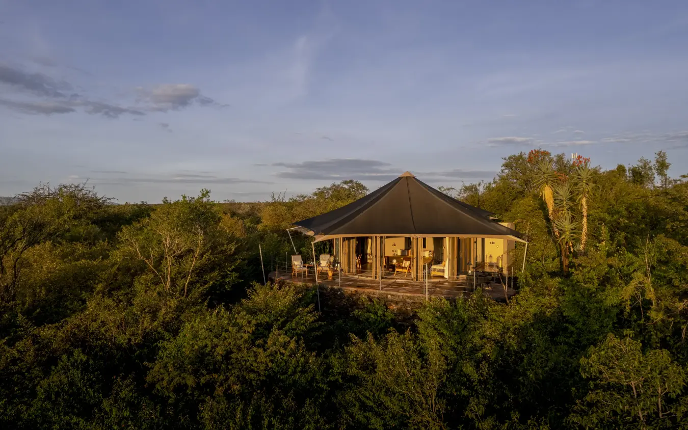 Luxury safari tent elevated above bushland at golden hour, Hemingways Ol Seki Mara, Maasai Mara, Kenya