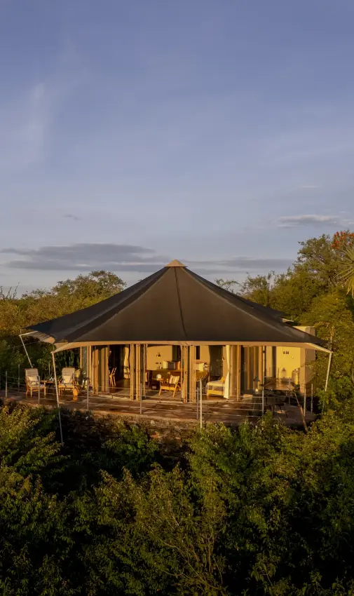 Luxury safari tent elevated above bushland at golden hour, Hemingways Ol Seki Mara, Maasai Mara, Kenya