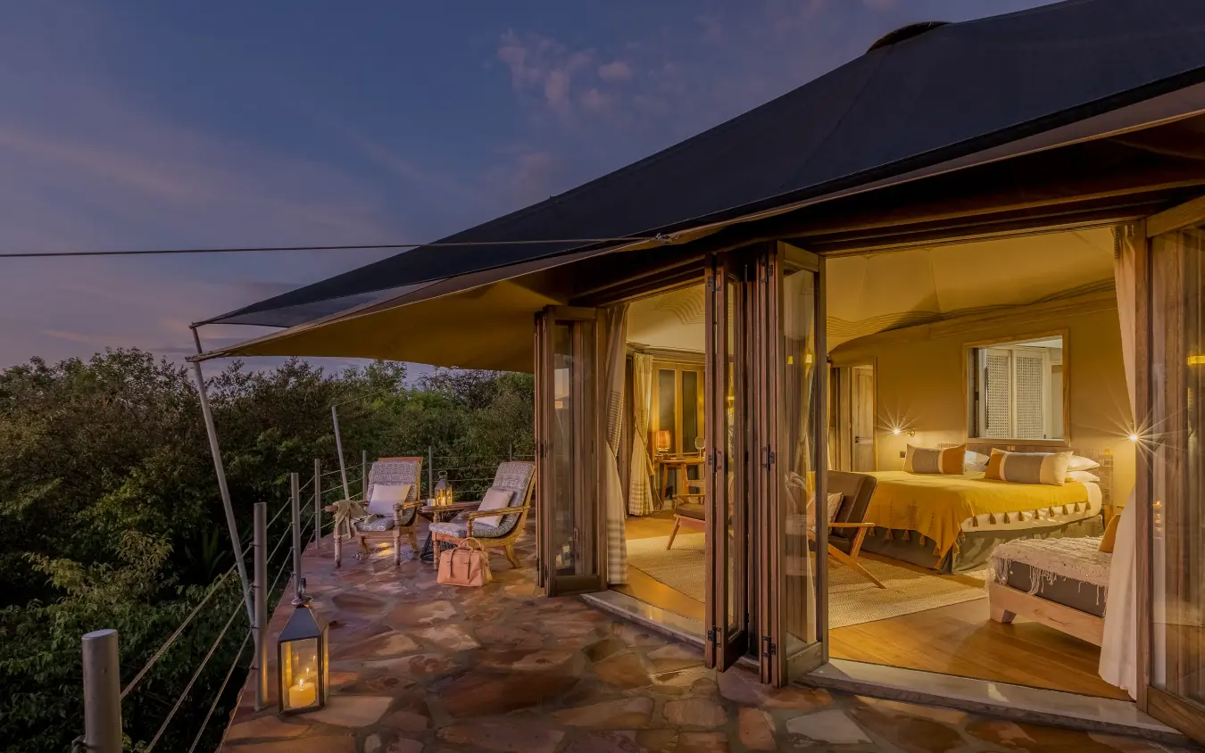 Luxury safari suite with open terrace overlooking woodland at dusk, Hemingways Ol Seki Mara, Maasai Mara, Kenya