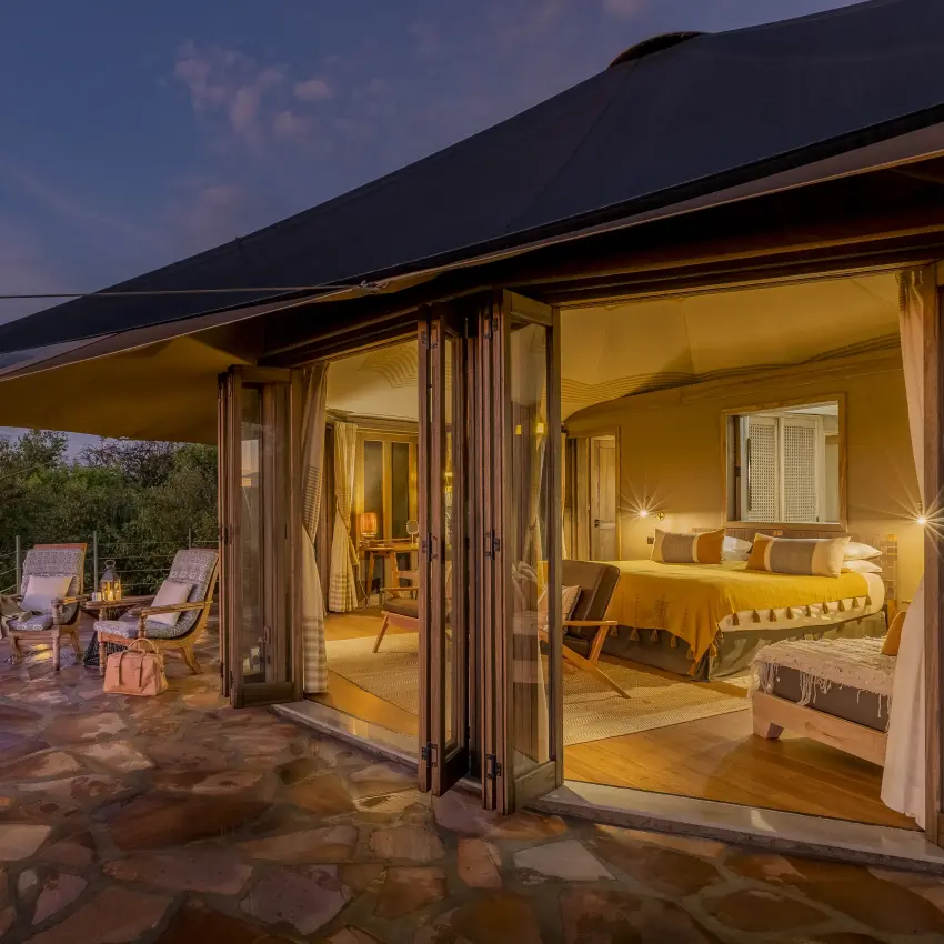 Luxury safari suite with open terrace overlooking woodland at dusk, Hemingways Ol Seki Mara, Maasai Mara, Kenya