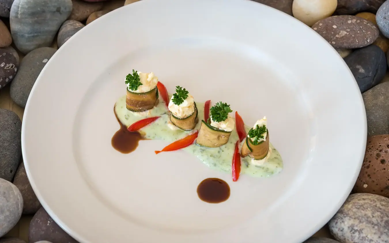 Plated gourmet dish with seared protein and garnish, Hoanib Skeleton Coast Camp, Skeleton Coast, Namibia