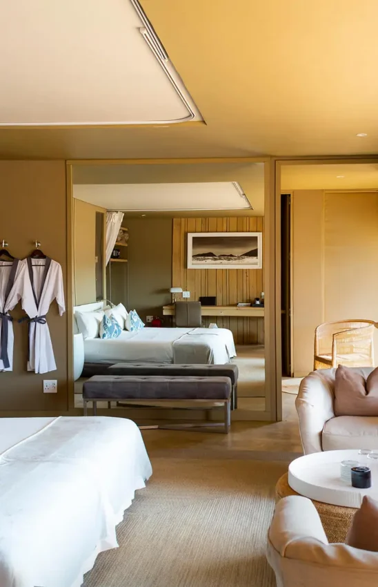 Spacious safari suite with bed, seating area, and desert views, Hoanib Skeleton Coast Camp, Skeleton Coast, Namibia