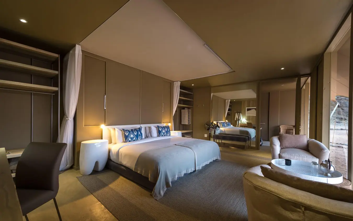 Spacious bedroom suite with canopy bed and sitting area, Hoanib Skeleton Coast Camp, Skeleton Coast, Namibia