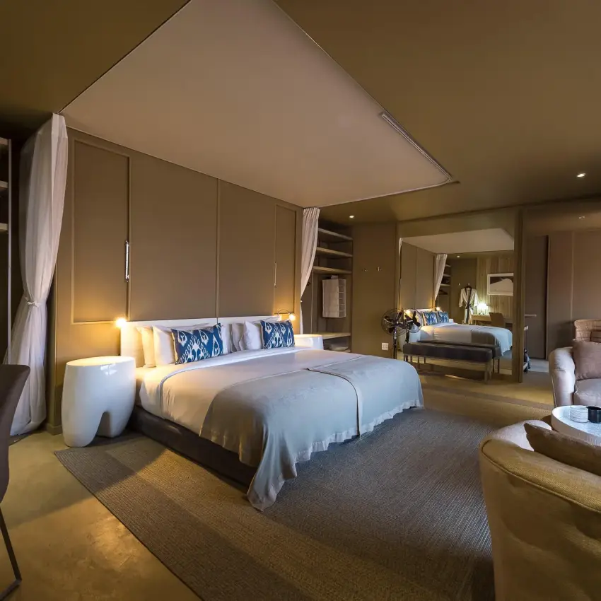 Spacious bedroom suite with canopy bed and sitting area, Hoanib Skeleton Coast Camp, Skeleton Coast, Namibia
