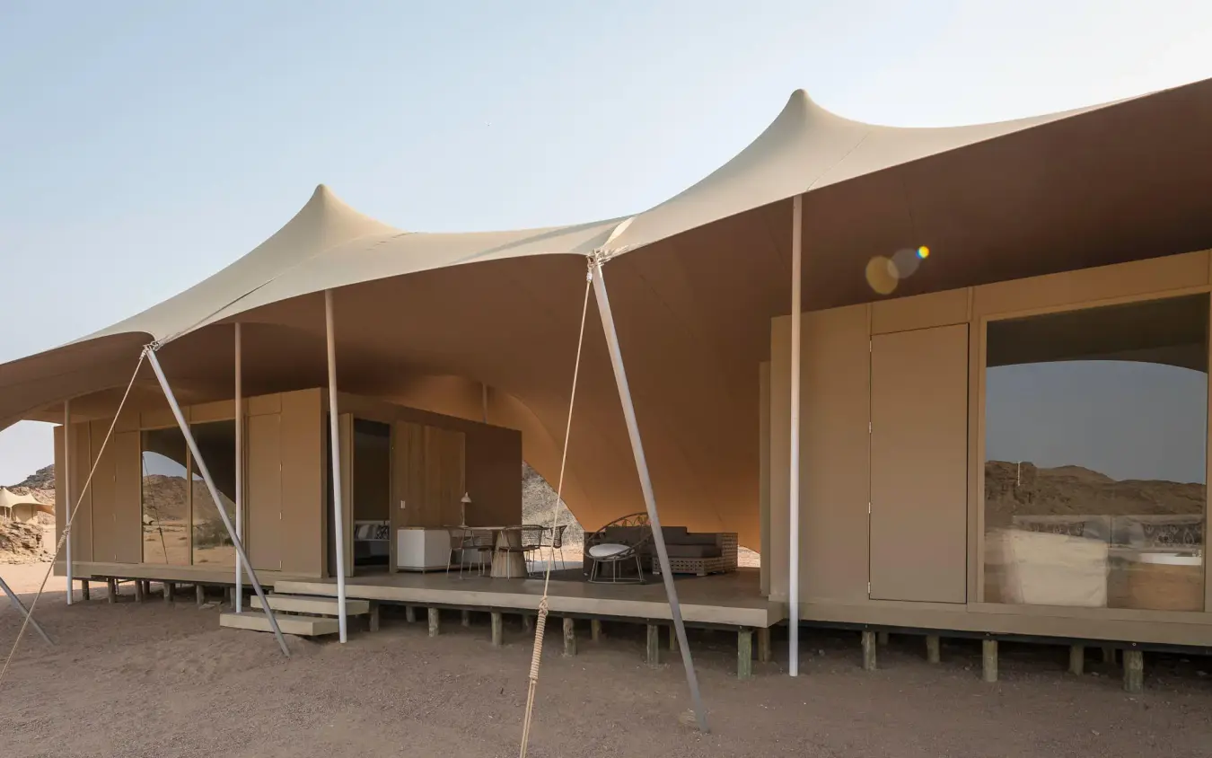 Canvas tent structures with peaked roofs in desert landscape, Hoanib Skeleton Coast Camp, Skeleton Coast, Namibia