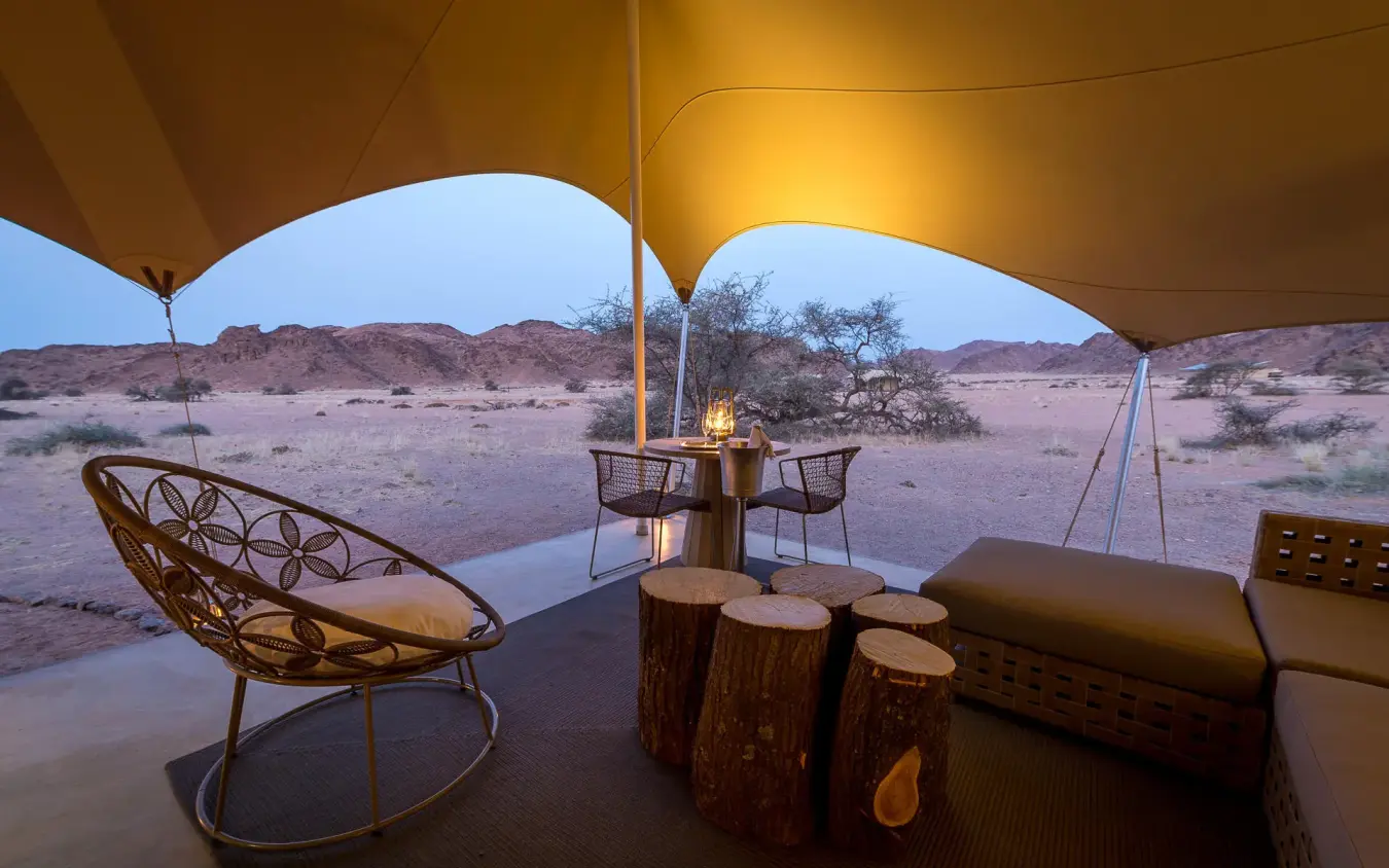 Desert lounge area with seating under canvas canopy, Hoanib Skeleton Coast Camp, Skeleton Coast, Namibia
