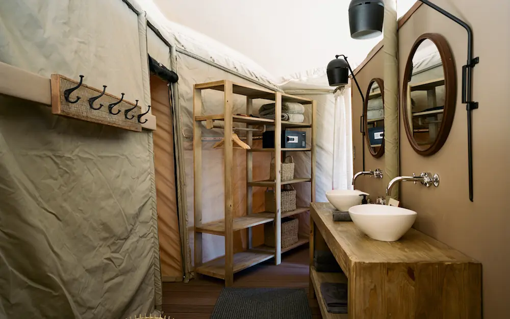 Luxury safari bathroom with wooden vanity and mirrors, Hoanib Valley Camp, Damaraland, Namibia