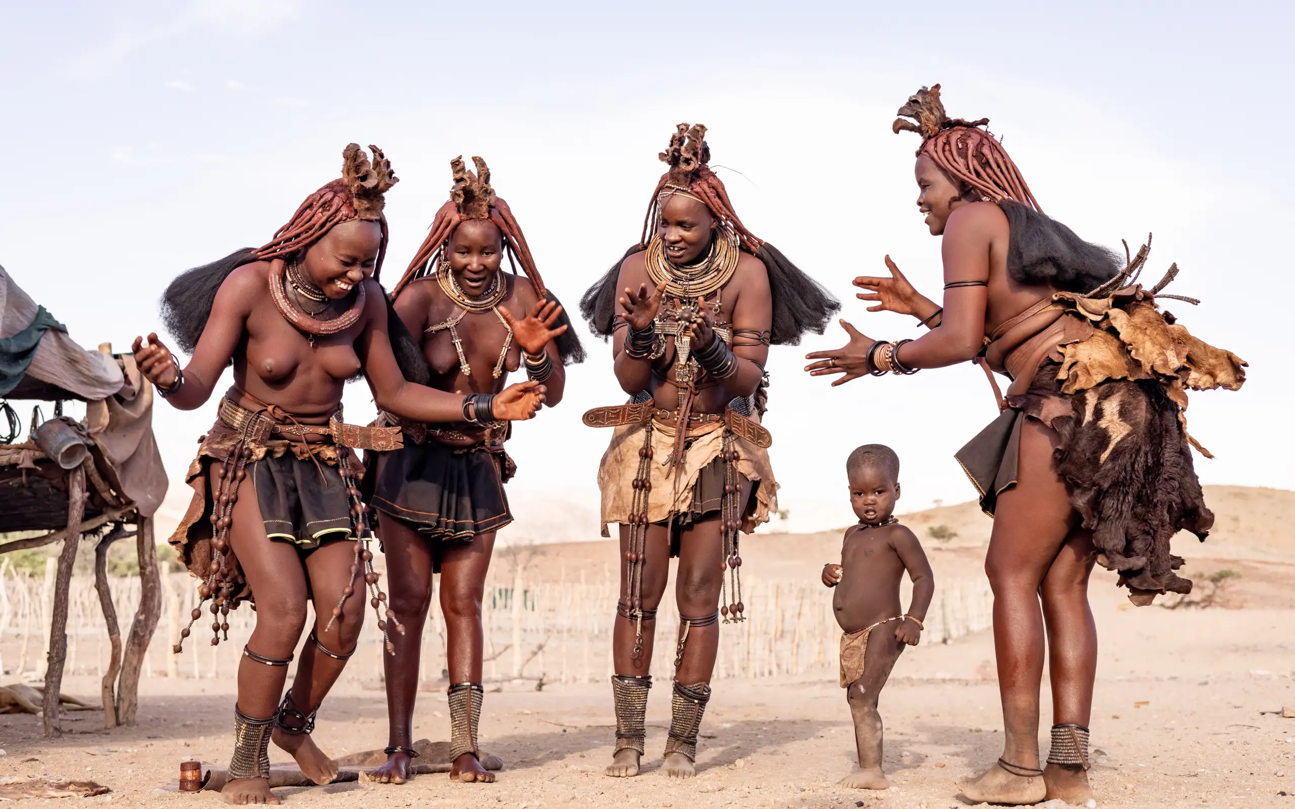 Himba community members in traditional dress and ornaments, Hoanib Valley Camp, Skeleton Coast, Namibia