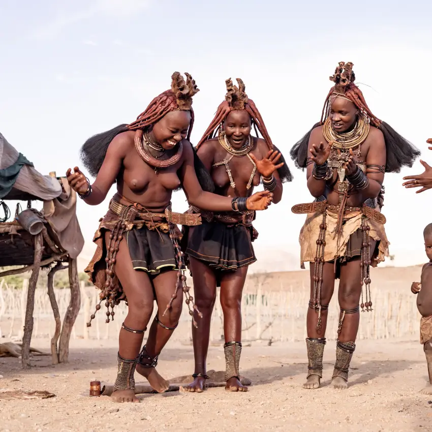Himba community members in traditional dress and ornaments, Hoanib Valley Camp, Damaraland, Namibia
