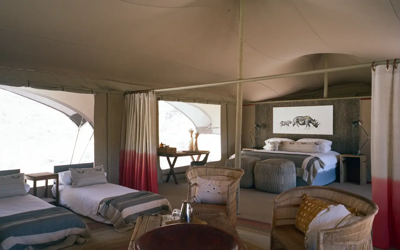 Spacious family tent interior with multiple beds and seating, Hoanib Valley Camp, Skeleton Coast, Namibia