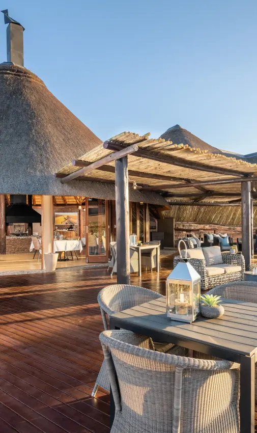 Thatched lodge main deck with dining and lounge areas, Hoodia Desert Lodge, Sossusvlei, Namibia