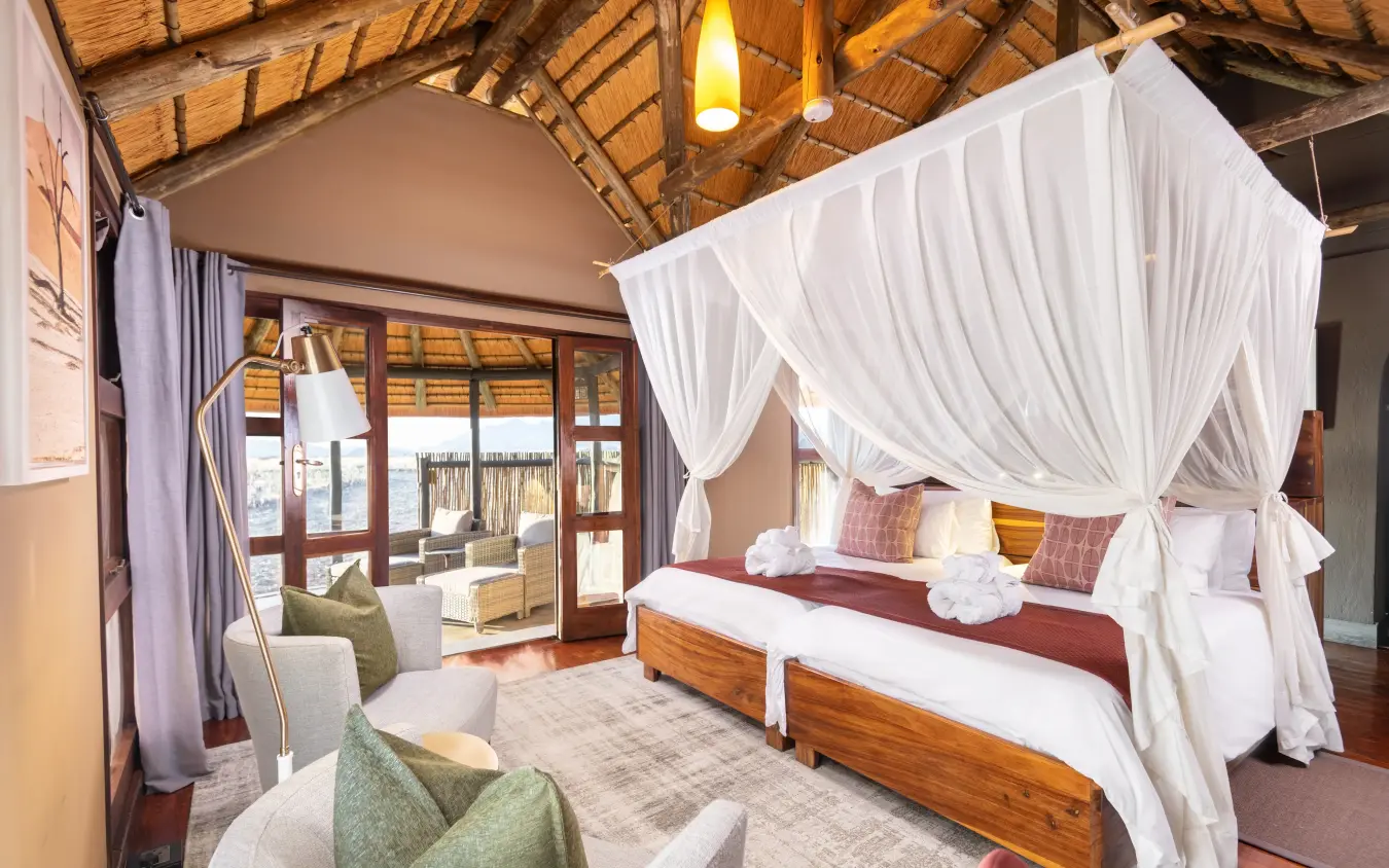 Luxury bedroom with four-poster bed and desert views, Hoodia Desert Lodge, Sossusvlei, Namibia