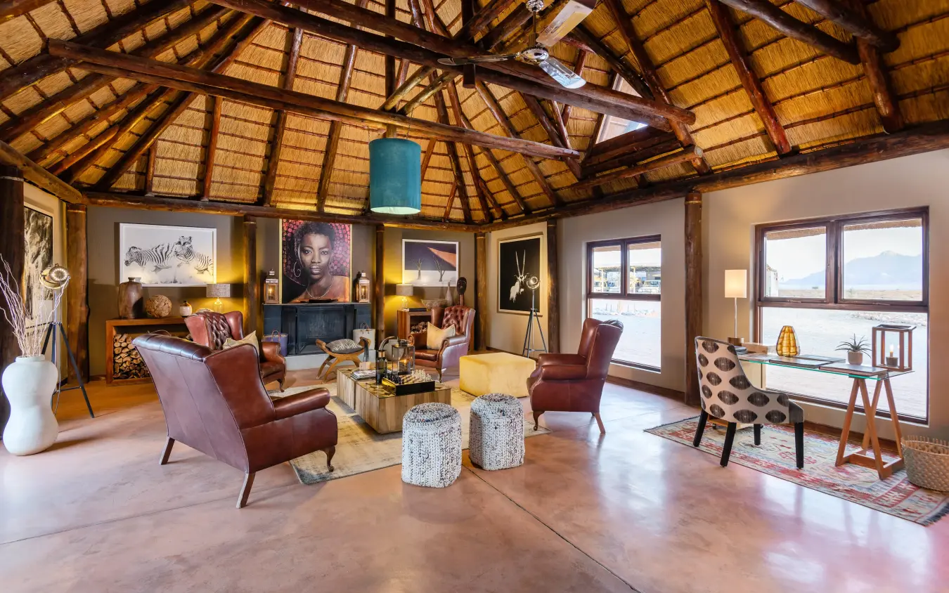 spacious interior lounge with high thatched ceiling and large windows, Hoodia Desert Lodge, Sossusvlei, Namibia