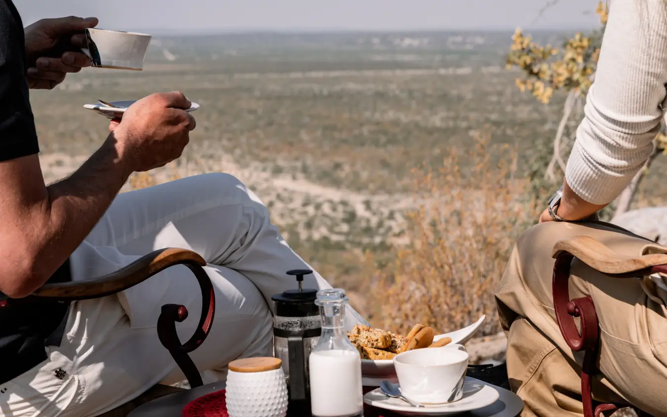 Picnic setup with elevated valley views overlooking forested landscape, Horizon by Ongava, Etosha National Park, Namibia