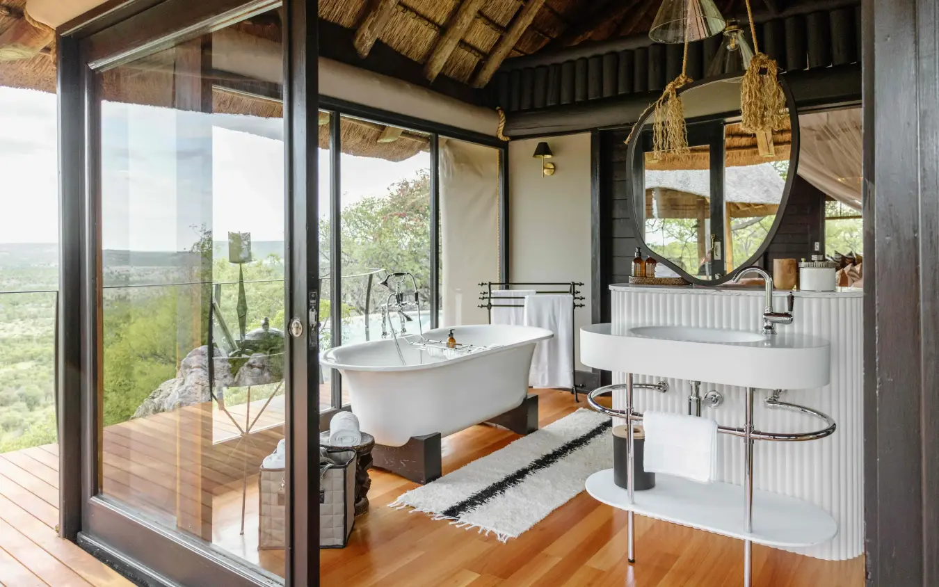 Luxury bathroom with freestanding tub and panoramic valley views, Horizon by Ongava, Etosha National Park, Namibia