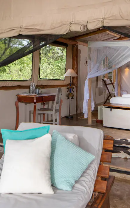 Open-air bedroom with beds overlooking savanna landscape, House In The Wild, Maasai Mara, Kenya