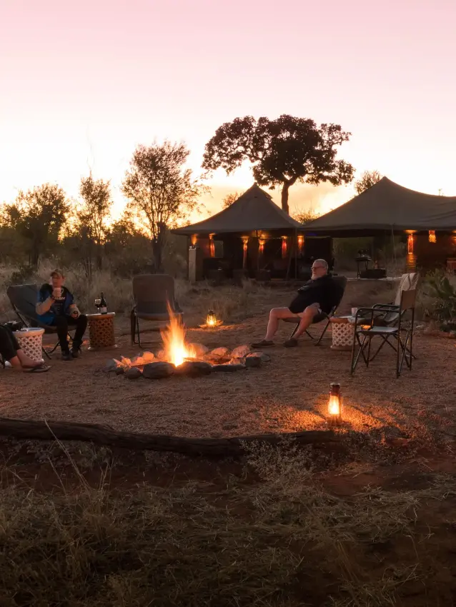 Evening gathering around campfire near lodge tent, Hwange Bush Camp, Hwange National Park, Zimbabwe