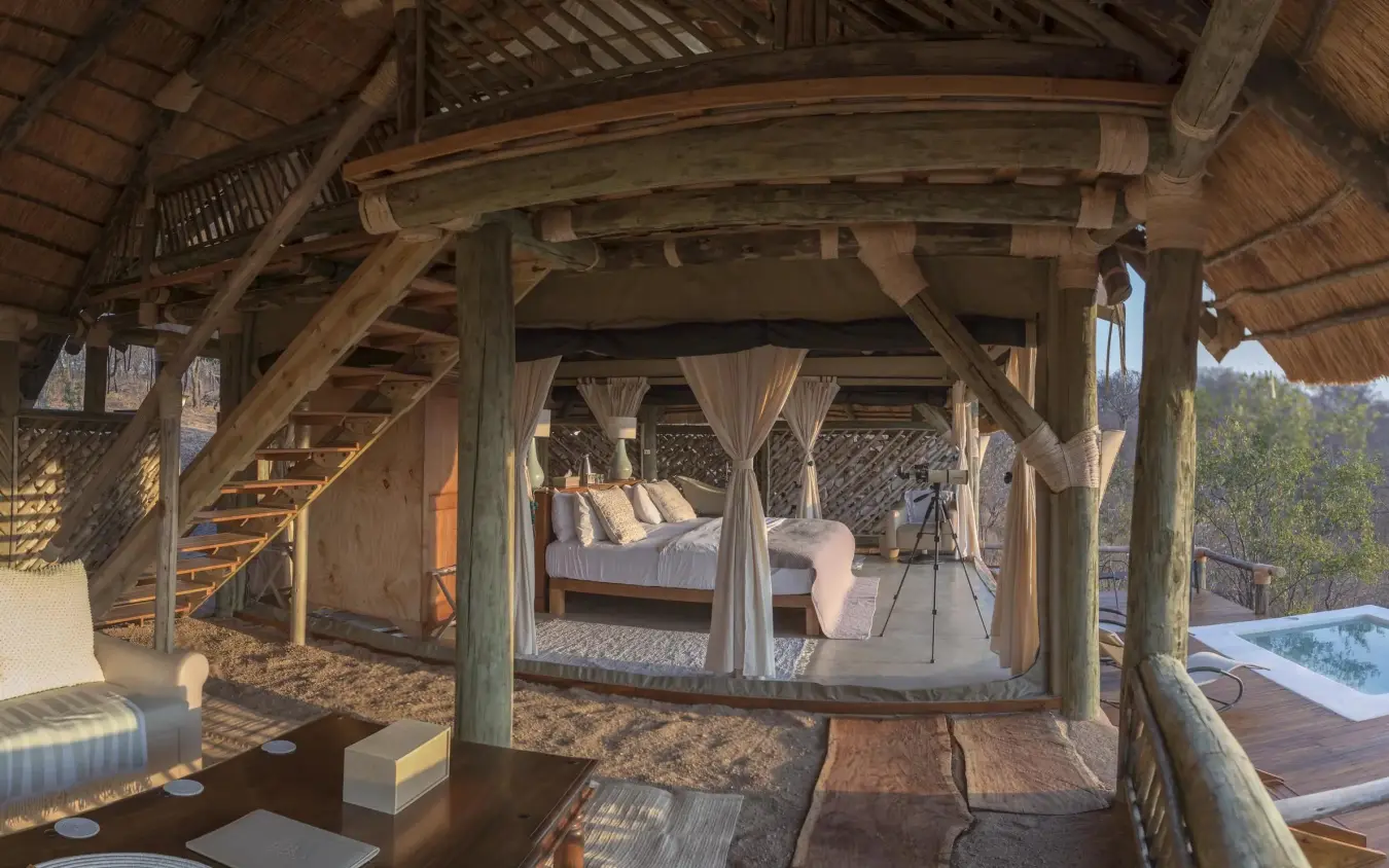 Wooden deck with seating area overlooking savanna landscape, Ikuka Safari Camp, Ruaha National Park, Tanzania
