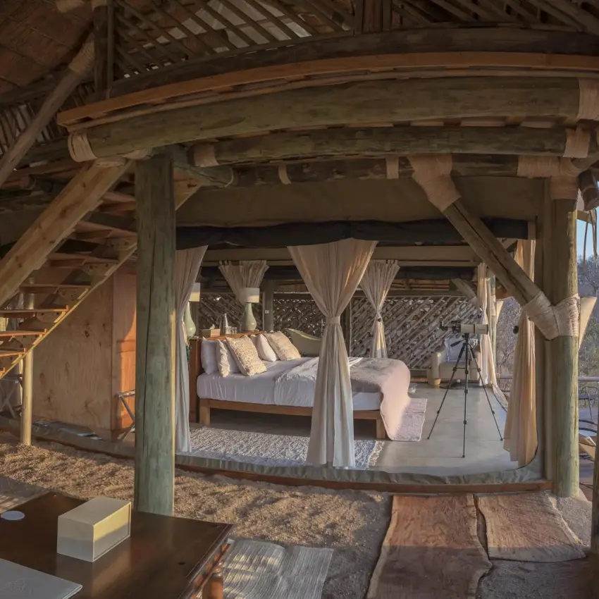 Wooden deck with seating area overlooking savanna landscape, Ikuka Safari Camp, Ruaha National Park, Tanzania