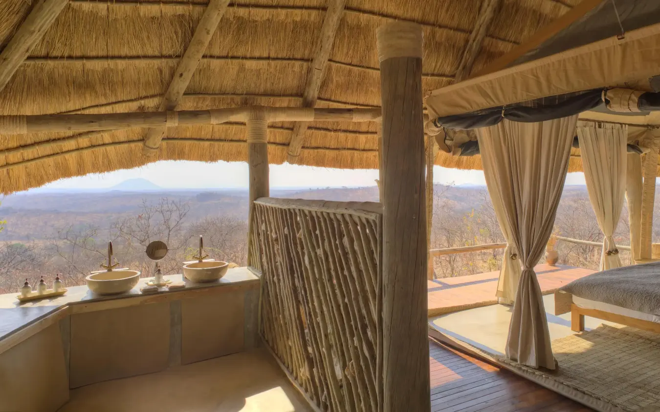 Open-air bedroom pavilion with savanna landscape views, Ikuka Safari Camp, Ruaha National Park, Tanzania