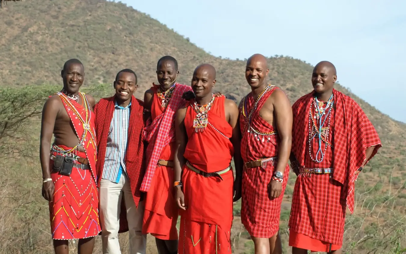 Group of Maasai men in traditional red clothing and beads, Il Ngwesi, Laikipia Highlands, Kenya