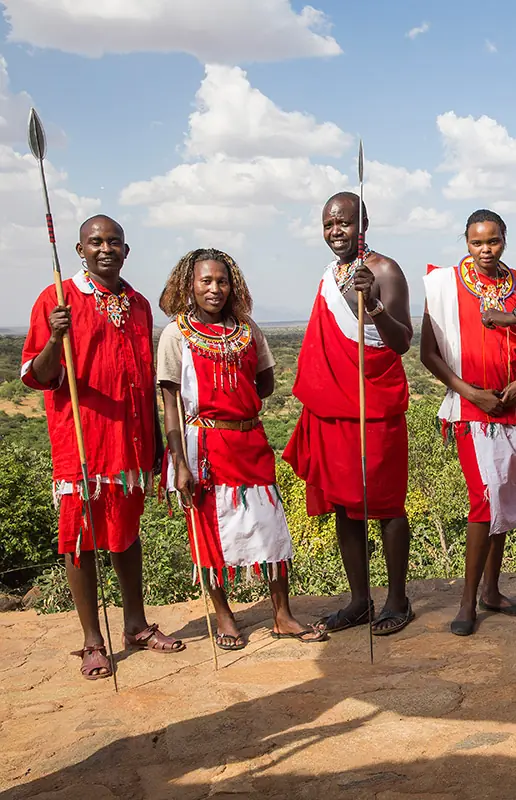 Group of Maasai warriors in traditional red clothing with spears, Il Ngwesi, Laikipia Highlands, Kenya