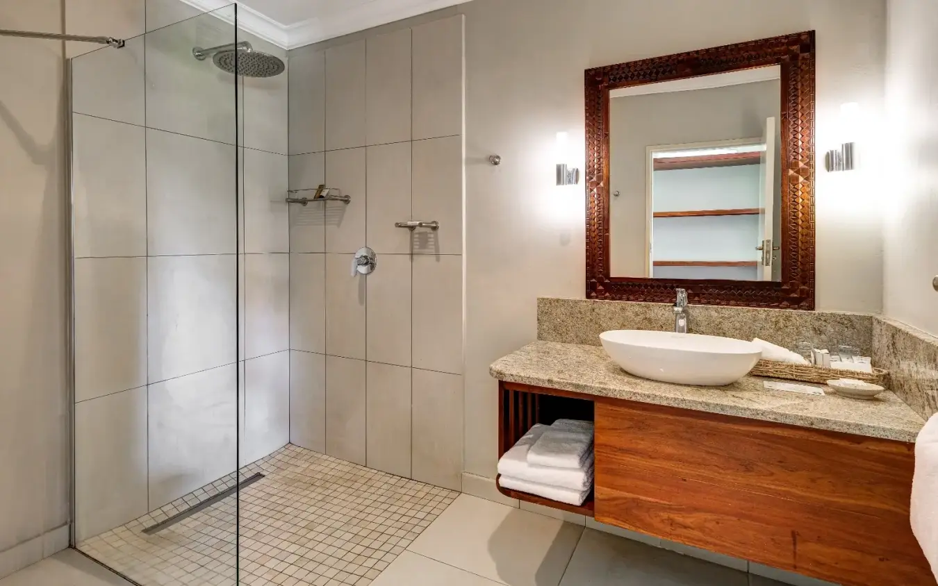 Modern bathroom with walk-in shower and granite vanity with vessel sink, Ilala Lodge Hotel, Victoria Falls, Zimbabwe