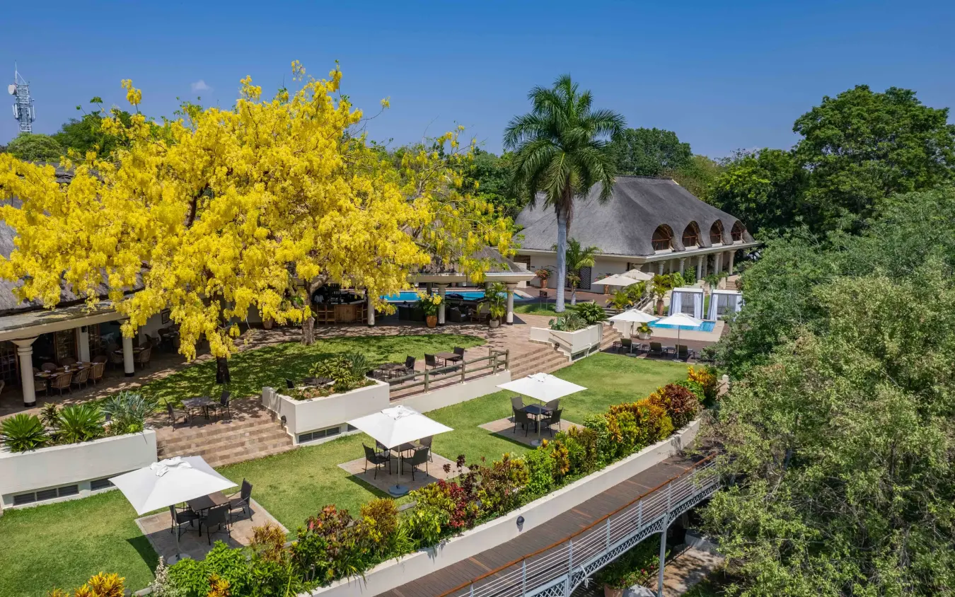 Luxury lodge with manicured gardens and river frontage overlooking woodland, Ilala Lodge Hotel, Victoria Falls, Zimbabwe