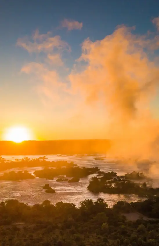 Aerial view of misty river valley at sunrise with forested islands, Ilala Lodge Hotel, Victoria Falls, Zimbabwe