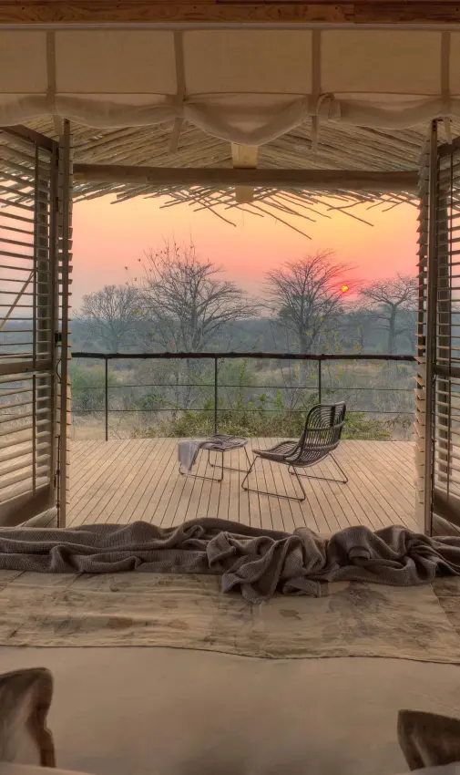 Open-air bedroom pavilion overlooking savanna at sunset, Jabali Ridge, Ruaha National Park, Tanzania