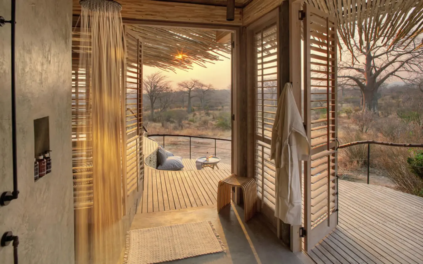 Wooden deck overlooking savanna landscape at sunset, Jabali Ridge, Ruaha National Park, Tanzania