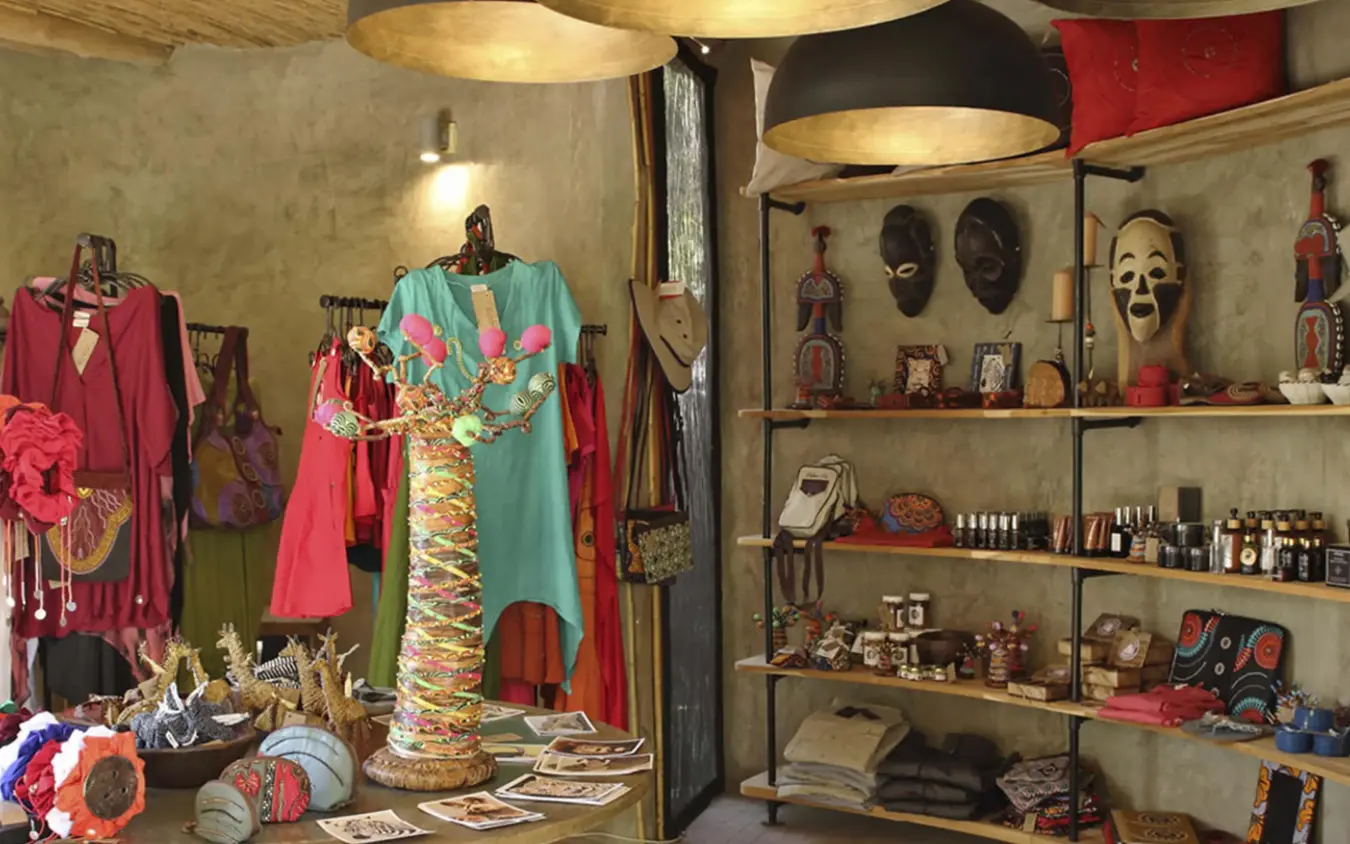 Interior shop display with colorful garments and tribal masks, Jabali Ridge, Ruaha National Park, Tanzania