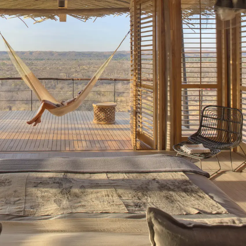 Bedroom with hammock on wooden deck overlooking savanna, Jabali Ridge, Ruaha National Park, Tanzania