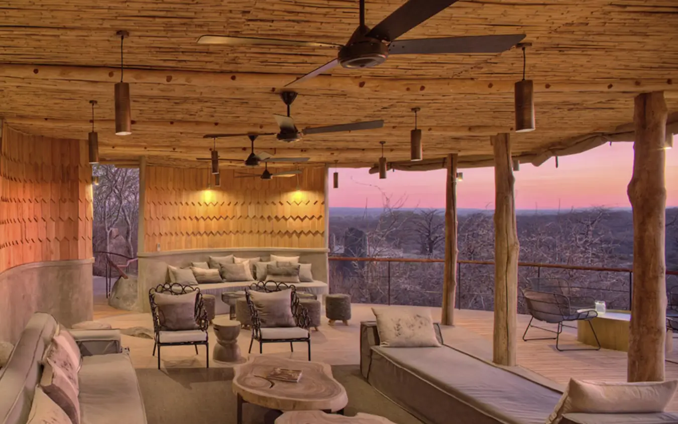Covered lounge area with seating overlooking savanna landscape at sunset, Jabali Ridge, Ruaha National Park, Tanzania