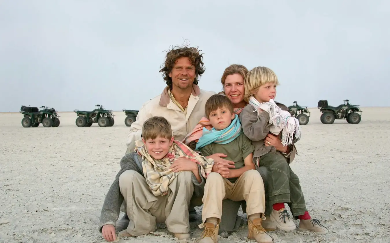 Family posing together on open desert landscape