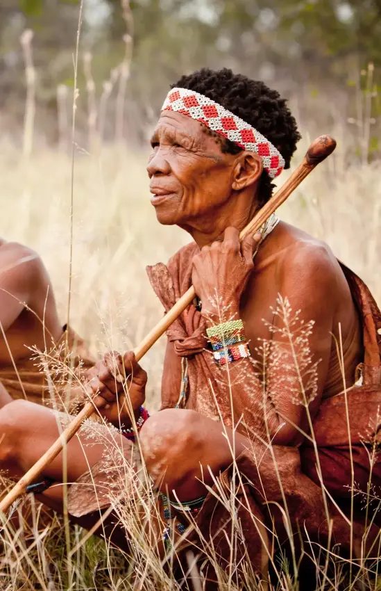Local guides demonstrating traditional hunting techniques in grassland, Jack’s Camp, Makgadikgadi Pans, Botswana