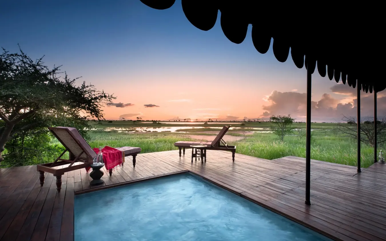 Wooden deck with pool overlooking wetland at sunset, Jack’s Camp, Makgadikgadi Pans, Botswana