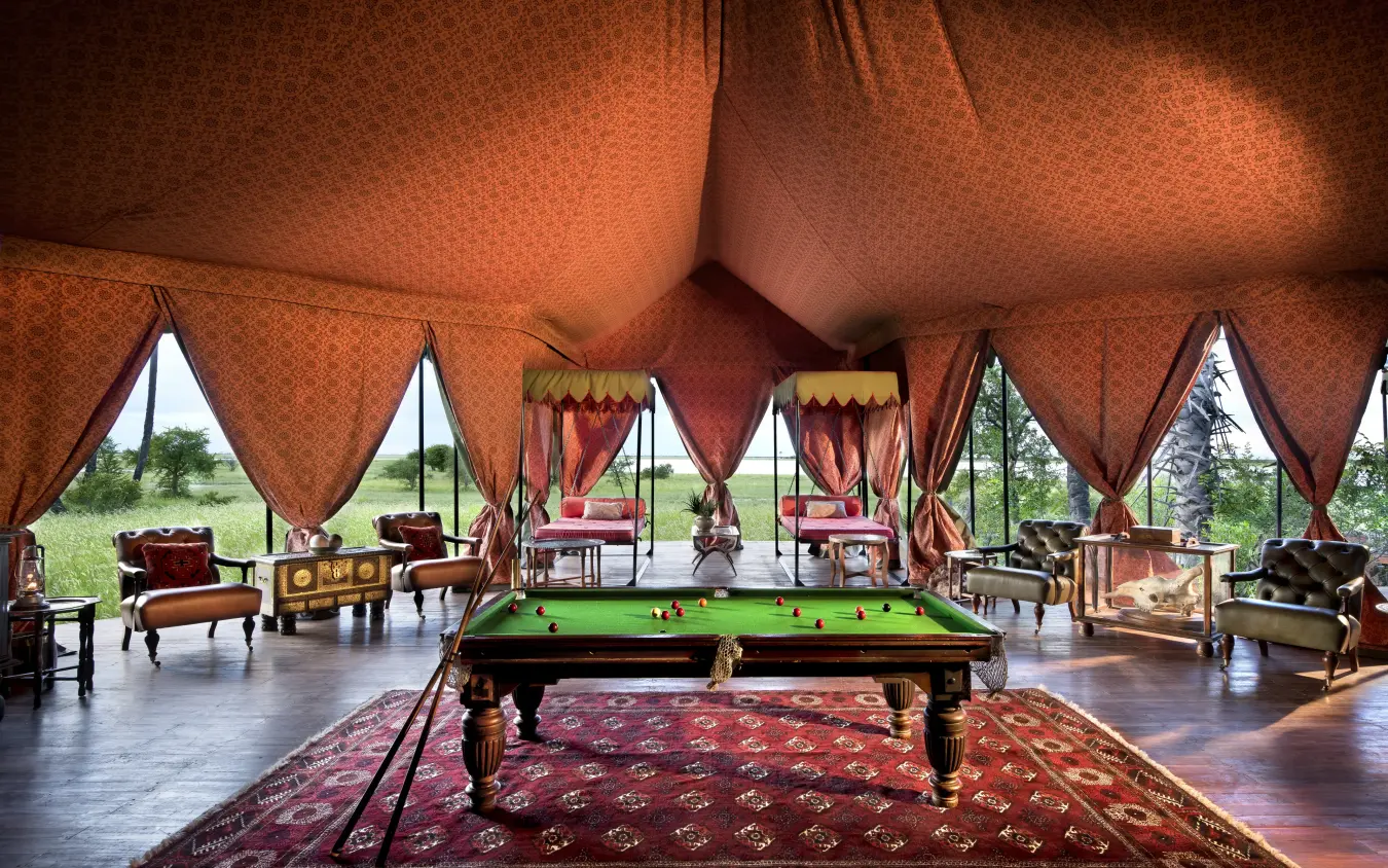Interior of orange canvas tent with pool table and seating, Jack’s Camp, Makgadikgadi Pans, Botswana