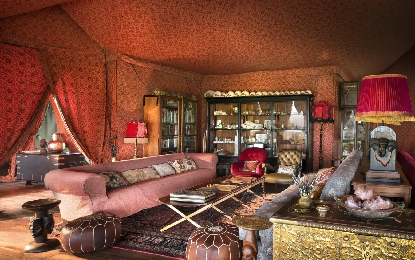 Luxurious tent interior with pink seating and red furnishings, Jack’s Camp, Makgadikgadi Pans, Botswana