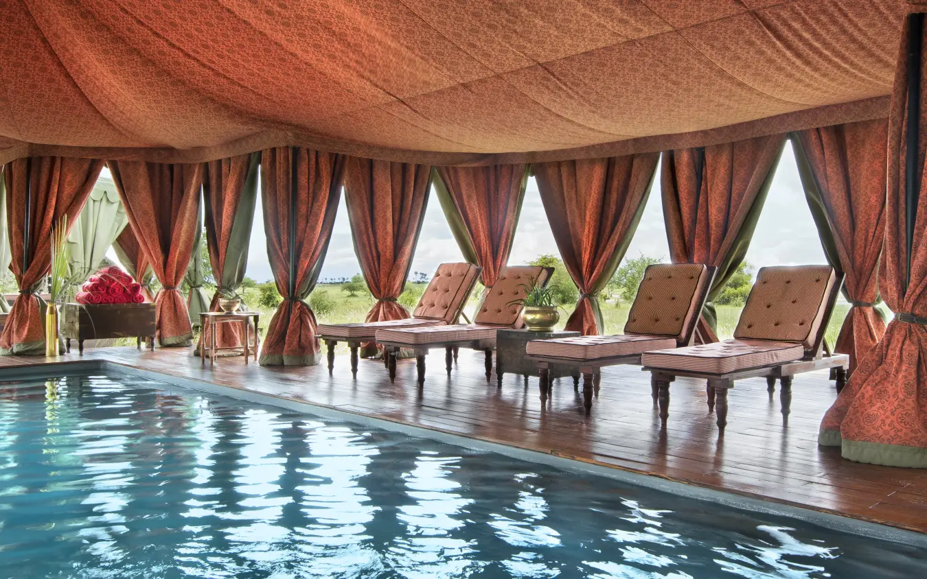 Indoor pool pavilion with draped fabric and lounge seating, Jack’s Camp, Makgadikgadi Pans, Botswana