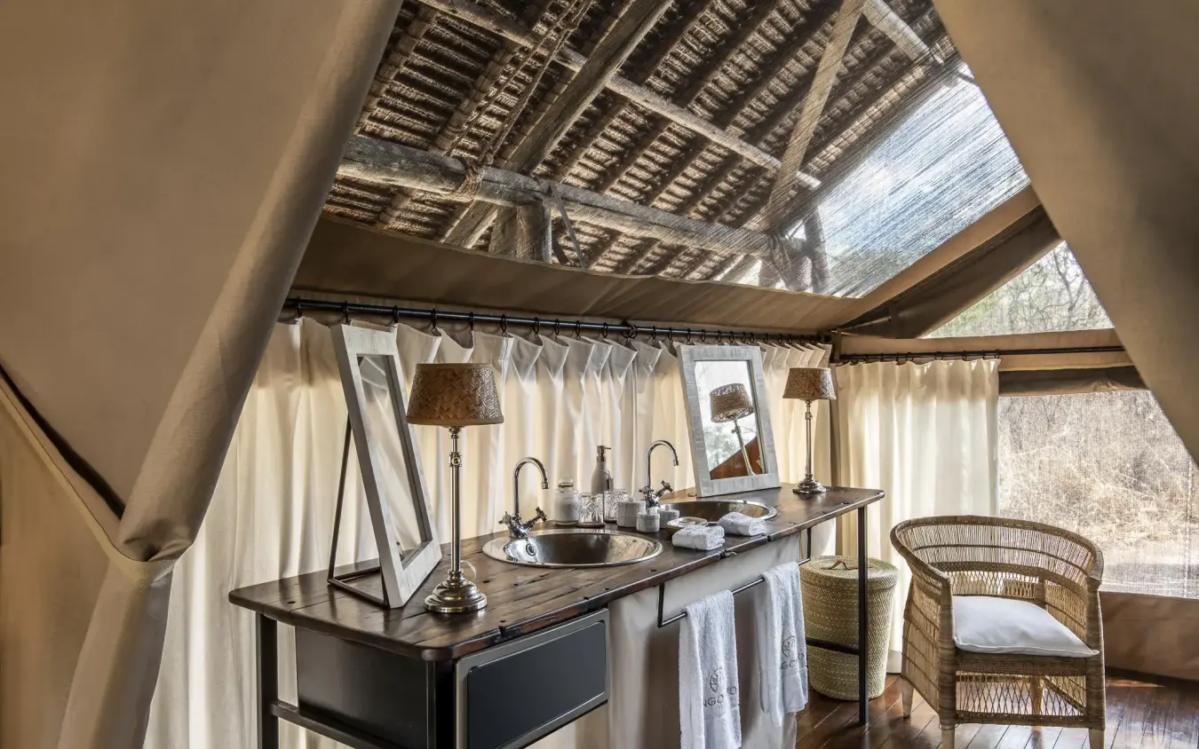 Outdoor bathroom with double vanity and natural wood beams, Jongomero Camp, Ruaha National Park, Tanzania
