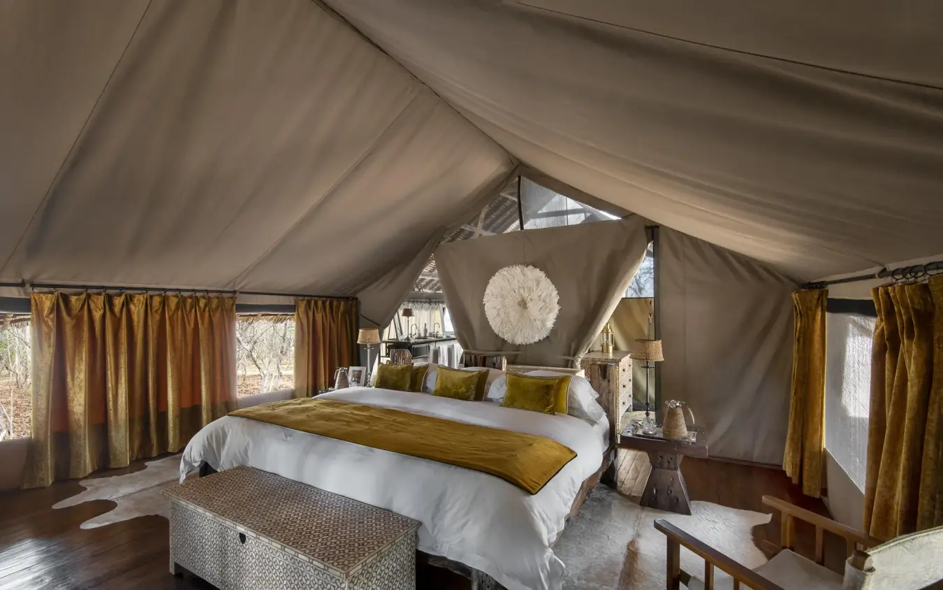 Luxurious safari tent bedroom with canvas walls and furnishings, Jongomero Camp, Ruaha National Park, Tanzania