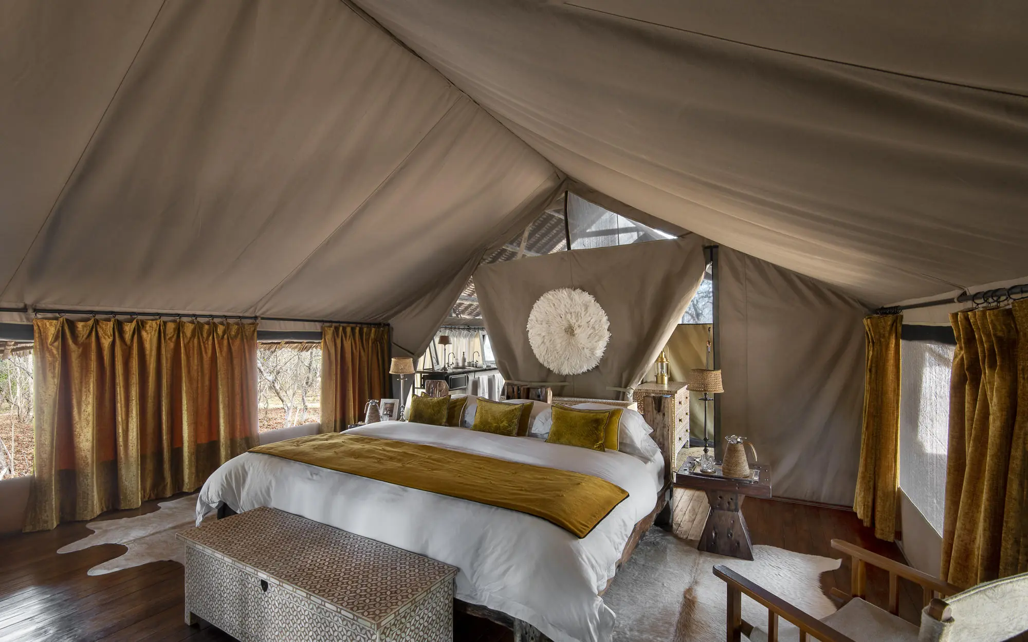 Luxurious safari tent bedroom with canvas walls and furnishings, Jongomero Camp, Ruaha National Park, Tanzania